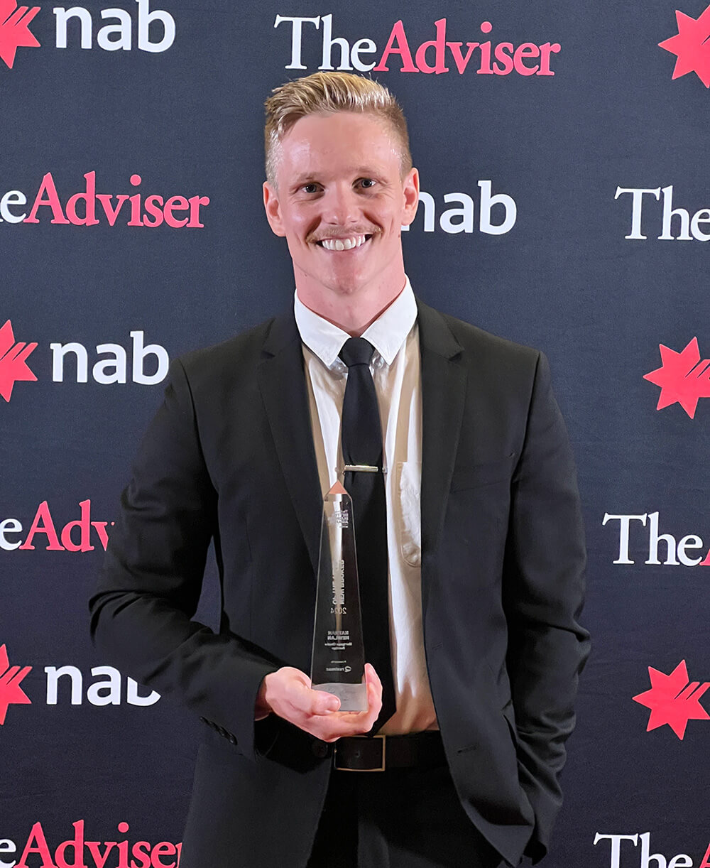 Mortgage Choice Bendigo broker Nathan Newlan shows the glass award that he won